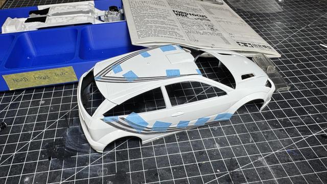 Body of a Ford Focus WRC with a copied decal on paper held in place by masking tape.