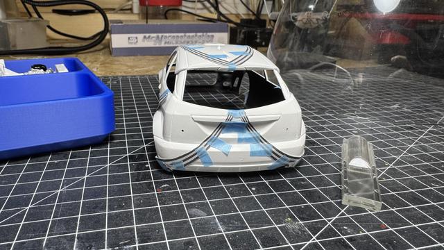 Body of a Ford Focus WRC with a copied decal on paper held in place by masking tape.