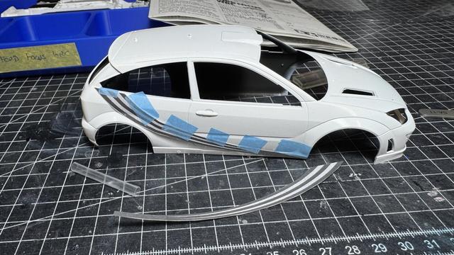 Body of a Ford Focus WRC with a copied decal on paper held in place by masking tape.