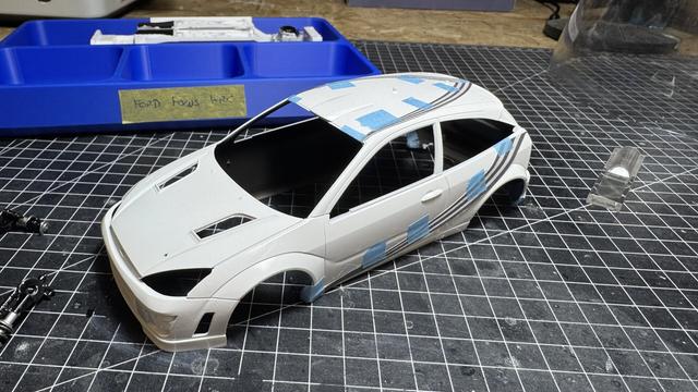 Body of a Ford Focus WRC with a copied decal on paper held in place by masking tape.