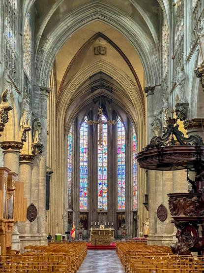 The image features a large stained glass window depicting various religious figures, with vibrant colors and intricate designs.