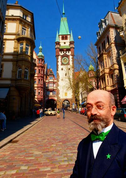 Zamenhof antaŭ mezepoka urbopordo de Friburgo. (AI kreita bildo surbaze de fotoj)