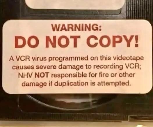 A warning label on a videotape cautioning against copying, stating that a "VCR virus" could damage recording devices and that NHV is not liable for any resulting damage.