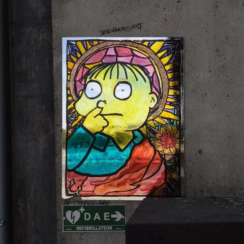 A portrait of Ralph from the Simpsons with his finger in his nose, on a mirror, in the style of religious icons.