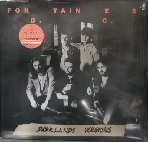 12 inch record cover of Darklands Versions by Fontaines D.C. Cover shows a black and white shot of the 5 band members, 3 are seating and the other 2 are standing.