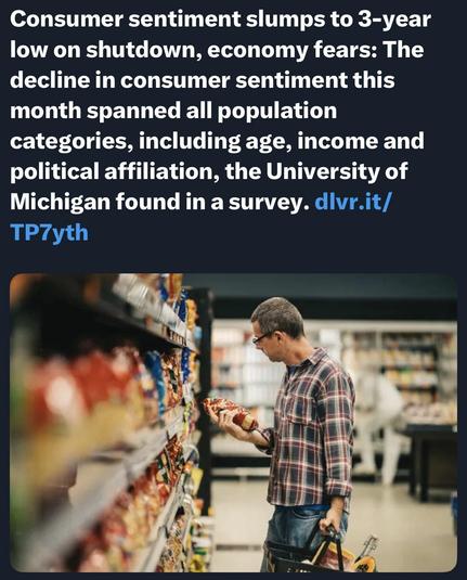 A man in glasses inspects a product while shopping in a grocery store. Shelves filled with packaged food items are visible in the background.