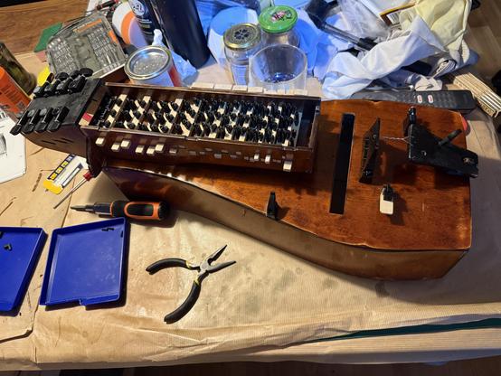 Photo of the hurdy gurdy with an open key box showing all keys having tangents.