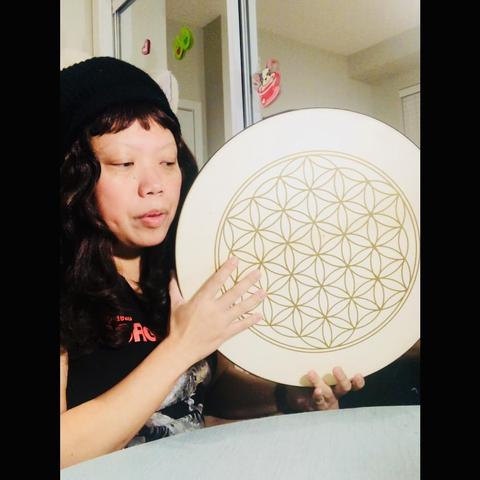 Crissy holds a Flower of life drum that’s 16”