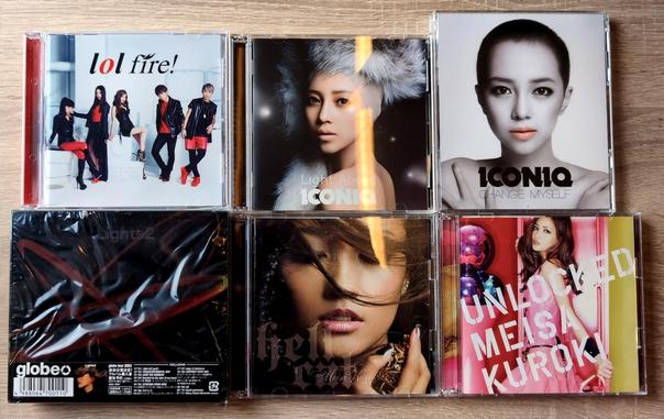 6 jewelcases with Jpop CDs on a table. Left to right, top to bottom: Lol's Fire, Iconiq's Light Ahead, Iconiq's Change Myself, Globe's Lights2, Meisa Kuroki's Hellcat, and Meisa Kuroki's Unlocked.