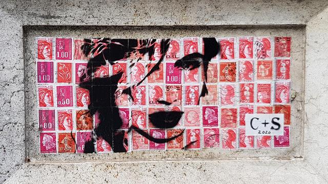 Drawing of a woman's face on pink French post stamps. Framed in a feature of a carved stone pillar.