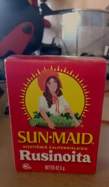 A small portion box of raisins on a table.