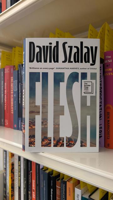 David Szalay's book "Flesh" on a shelf filled with new books