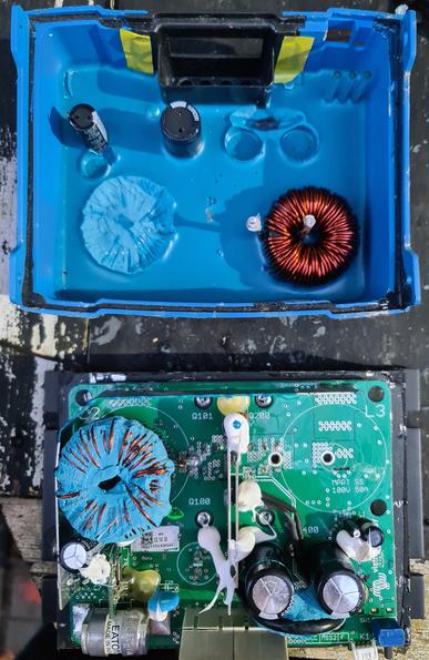 Upper section shows the inside top of the charge controller, showing a shitload of sealant, with 2 ripped off capacitors, and a ripped off transformer coil on the bottom right stuck in the sealant.
The bottom section shows the rest of the change controller, with a circuit board and some components still attached, and a massive fuse at the bottom left of the board.
