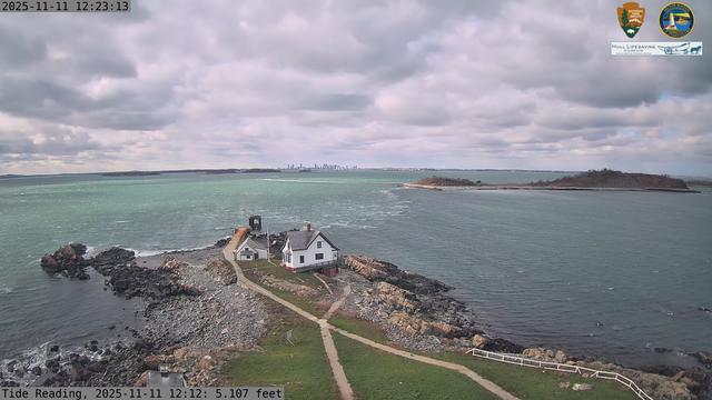 Camera looking west from Boston Light on Little Brewster Island. View looks toward downtown Boston in the distance, with several islands including Great Brewster and Georges Island in the midground.