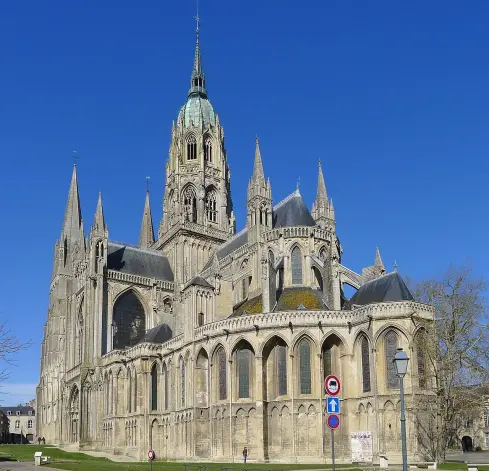 The image depicts a large and impressive Gothic cathedral featuring intricate architectural elements such as spires, pointed arches, and large windows. The building is characterized by its detailed stonework and a distinctive tower topped with a dome. The background showcases a clear blue sky, enhancing the cathedral's grand appearance. This type of structure is often found in historical European cities and may be associated with religious significance.

Image Credits: Wikimedia / Mbzt / CC BY-SA 3.0