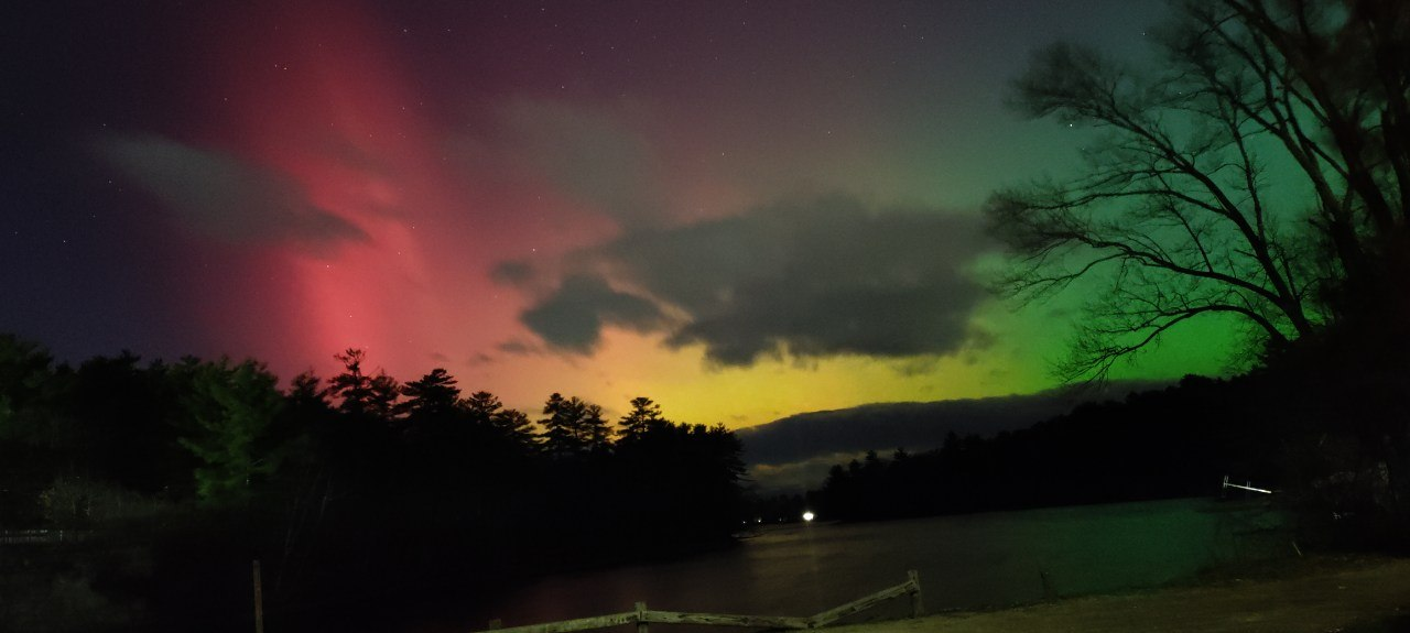 A red hue appears in the night sky as northern lights put on a show.