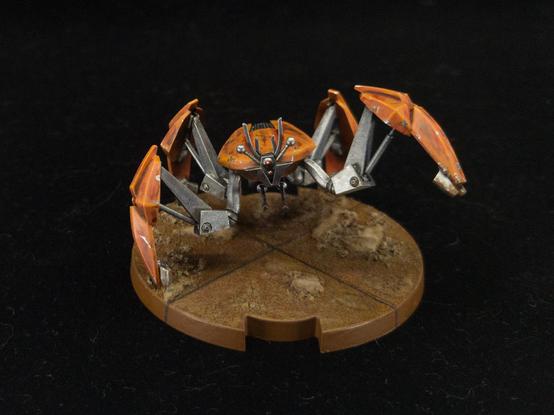 Painted crab droid mini for Star Wars Legion, showing front details and upraised leg.