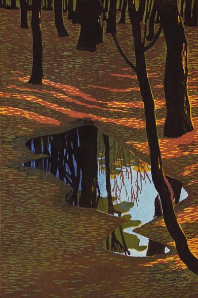 An autumn day in a forest in Japan. A faint trail leads away through the surrounding trees, discernible mostly as a slight depression in the ground and a clear track through the fallen leaves scattered across the forest floor. Late afternoon sunlight comes slanting through the trees at an angle, creating long shadows. Just ahead, a still puddle lies across the trail, reflecting the tops of the trees and the cloudless blue sky above.