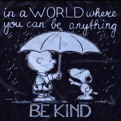 A white on black cartoon.

Charlie Brown, a boy from the comic strip "Peanuts" shelters the dog Snoopy with an umbrella against the rain.

Text: "In a world, where you can be anything: Be kind"