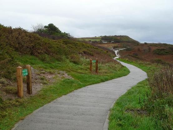 Upgraded Gower coast path showing a wide concrete section between Rotherslade and Limeslade, designed for easier access.
