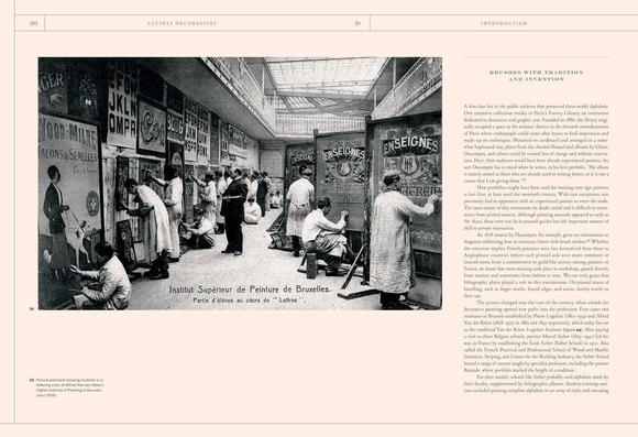 Graphic of a spread from a book with a column of text on the right and a black and white landscape image sitting across the fold. The image shows a school/workshop setting with multiple people painting large signs.