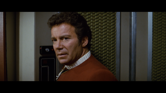 A shot from Star Trek II: The Wrath of Khan showing an upset Kirk talking to McCoy (who is off-camera) in an Enterprise turbolift.