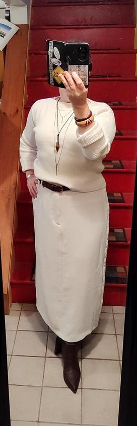 White sweater, white column skirt. Brown suede belt, brown knee boots. Wooden and gold jewelry.