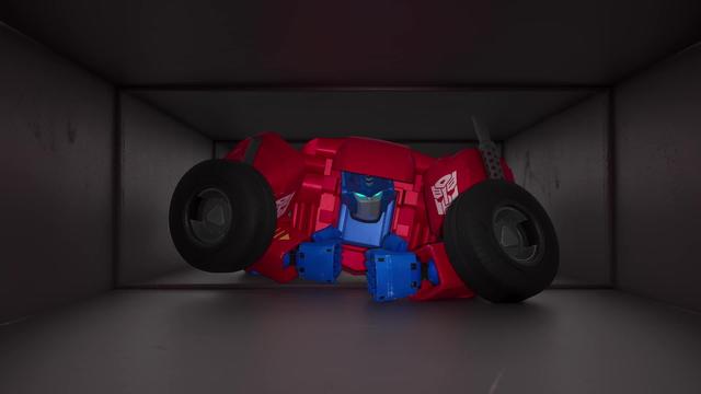 Optimus Prime crawling through a ventilation shaft in Transformers: CYBERWORLD.