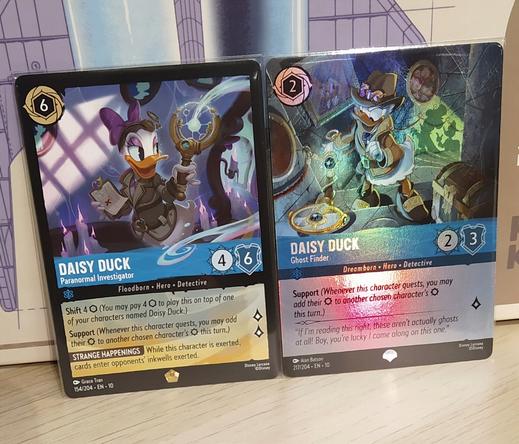 Two cards from the card game Lorcana. Daisy Duck - Paranormal Investigator (legendary) and Daisy Duck - Ghost Finder (epic).