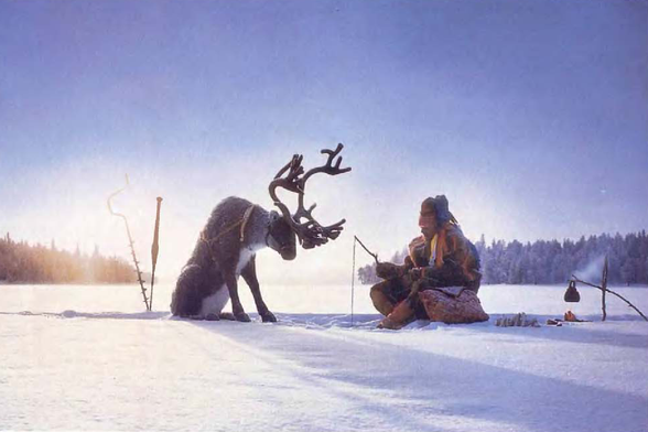 1992 Arctic Serenity - Human-Reindeer Bond
The image portrays a serene winter landscape in an arctic setting where a human figure sits beside a reindeer, seemingly engaging with the animal.
They are surrounded by snow-covered grounds and trees under a clear blue sky, indicating cold but calm weather conditions.