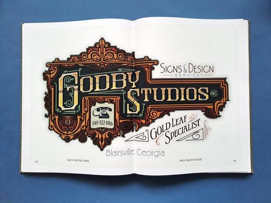 Full-page spread showing an elaborate sign design for 'Godby Studios'.