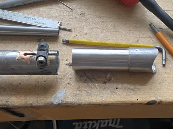 Detail of a splitable bicycle downtube
It has a stainless steel inner tube and cro-mo outer tubes, with a copper star and a binder bolt