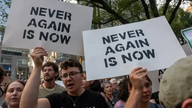 Jewish activists hold signs reading "Never again is now" during a protest against Israel's war on Gaza in New York on 4 August 2025 (Spencer Platt/Getty Images via AFP)