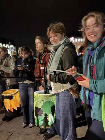 Menschen mit Laternen bei Nacht