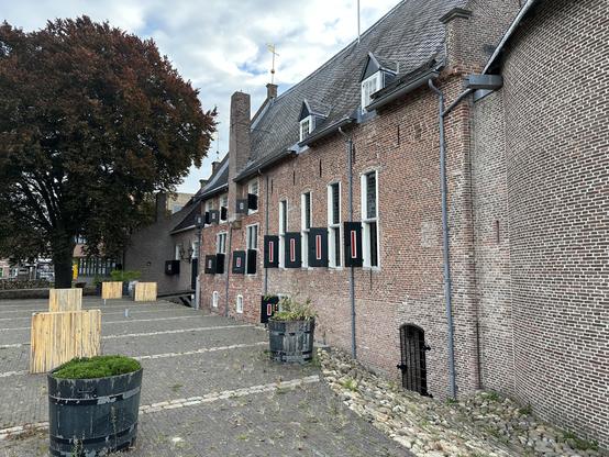 Green, red and white window shutters on the outside of the castle.