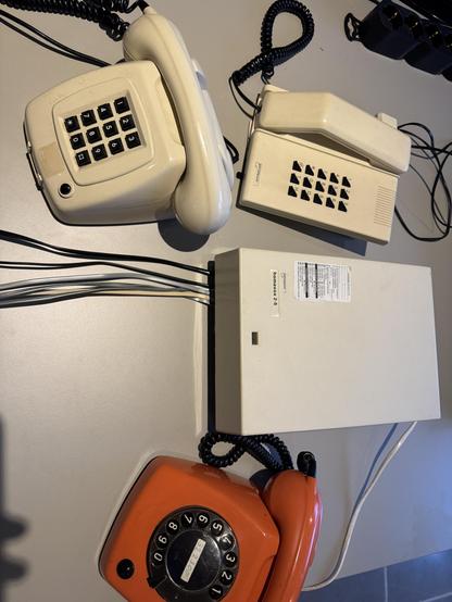 Picture of old dutch home phone system with a couple of terminals/old fashioned phones.