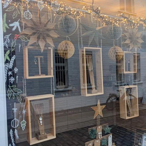 Close-up of the hanging wooden boxes, with paper stars and fairy lights.