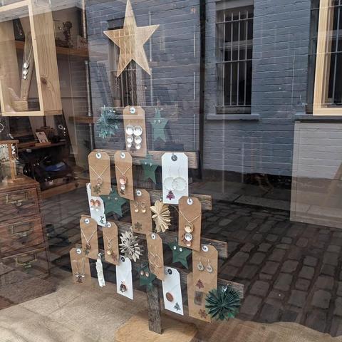 Close-up of the Christmas tree shaped display of jewellery items on cards