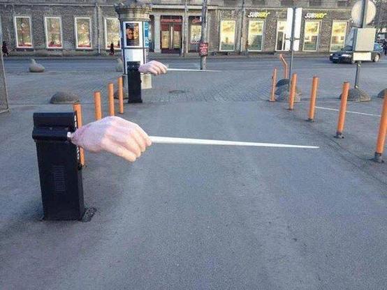 Estonian National Opera car park barriers.
The barriers are designed as conductor's hands: a giant hand holds a tapering, white baton, which blocks the drive. The boxes with the mechanism to lift them are painted black, slightly suggesting a person in a suit.