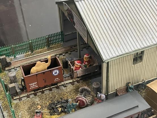 An open top wagon with a camel in it