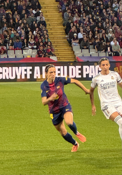 Aitana Bonmati runs ahead of a Real Madrid player