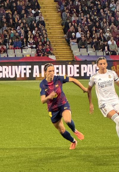 Aitana Bonmati runs ahead of a Real Madrid player