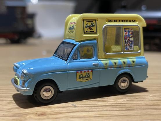 An old fashioned blue and yellow ice cream van