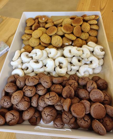 A tray with honey biscuits, vanilla biscuits, and chocolate crinkles.