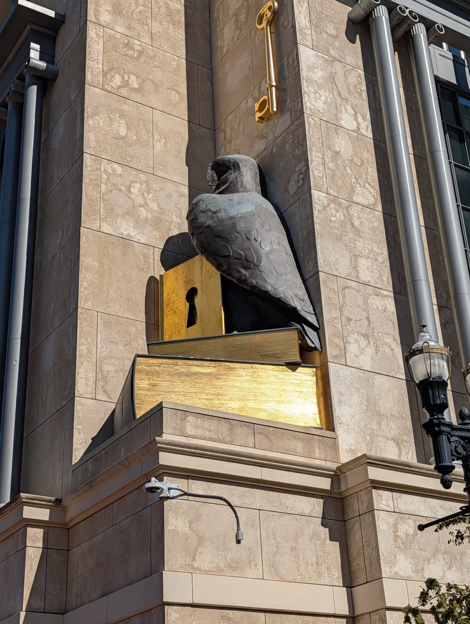 A big bronze eagle on top of books.