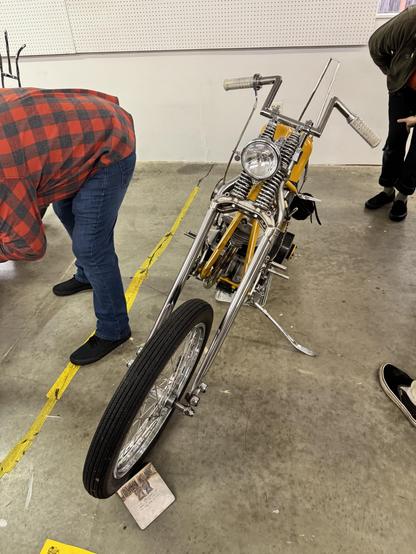 John Kunk’s 79 H-D FX.  Golden yellow paint, springer suspension, good rake, 4 inch apes, fully custom.