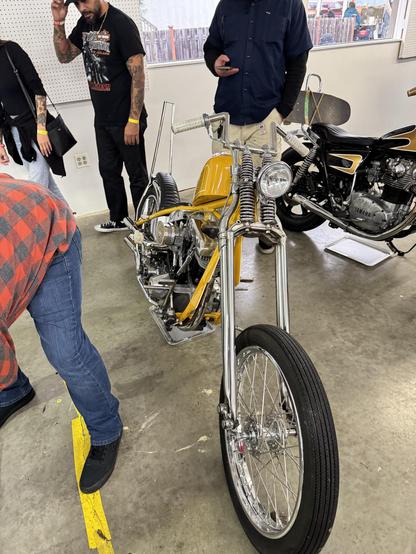 John Kunk’s 79 H-D FX.  Golden yellow paint, springer suspension, good rake, 4 inch apes, fully custom. Right side