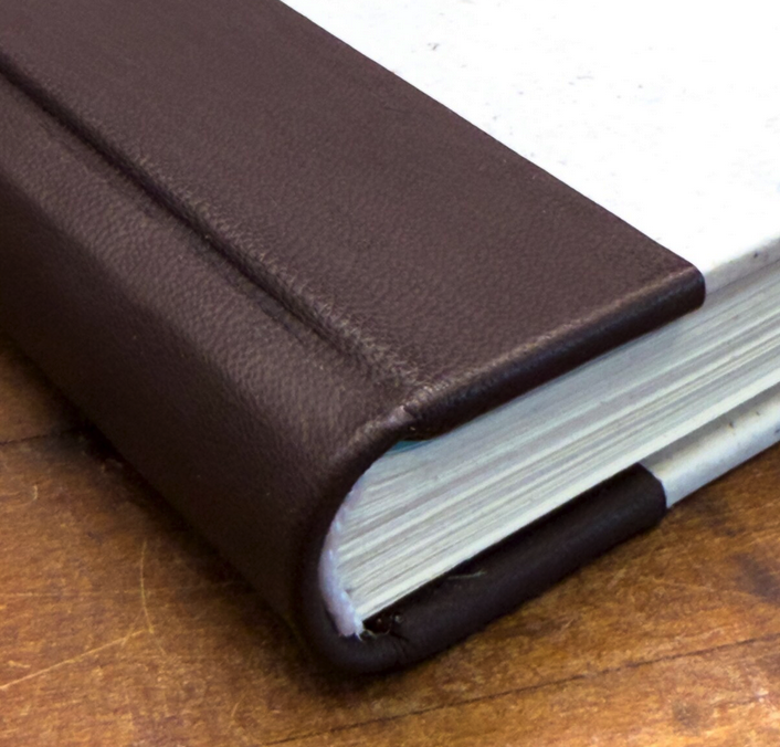 This is also a nice hand bound book, but there have been some "short cuts" the headband is present, but it's machine made, just a strip of fabric to protect the top of the signature folds. This is still a fairly high quality book, but not in the same league as the first one.