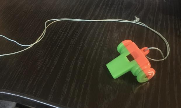 Plastic whistle on a table