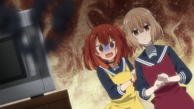 A still from the anime "This Monster Wants to Eat Me". Two girls are standing looking at a small oven, which has smoke billowing out of it despite being closed. One is watching it with a somewhat neutral expression. The other looks on with a horrified look on her face, clutching at the first girl.